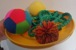 image - frisbee with rope, balls, and other items for a relay race